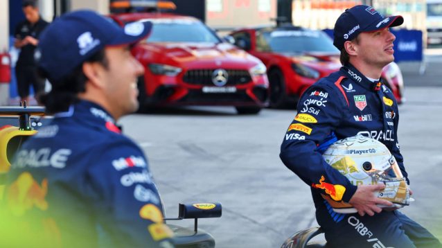 Sergio Perez and Max Verstappen sit on the RB20 for Red Bull's end-of-season photocall in Abu Dhabi