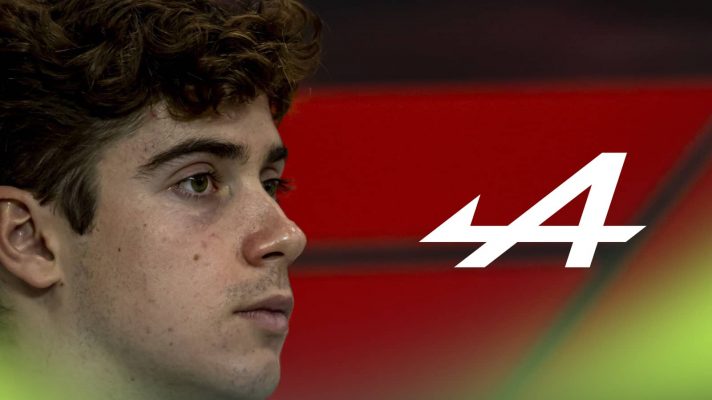 A side-profile shot of Franco Colapinto with a prominent Alpine logo alongside him