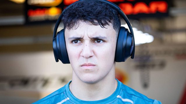 Isack Hadjar, looking serious and wearing headphones at the 2024 Abu Dhabi Grand Prix