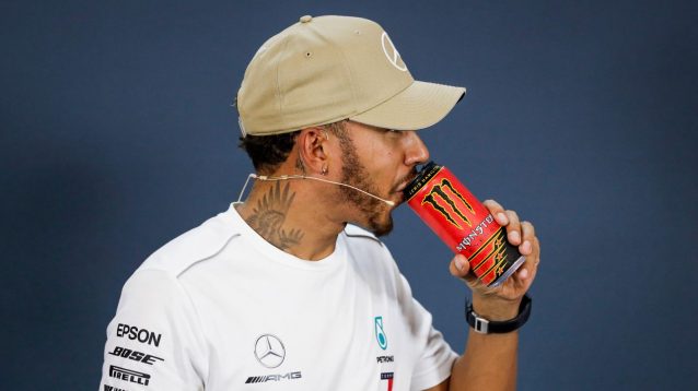 Lewis Hamilton sips a Monster Energy drink.