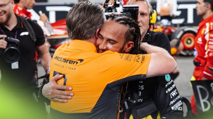 Zak Brown and Lewis Hamilton embrace on the grid in Abu Dhabi