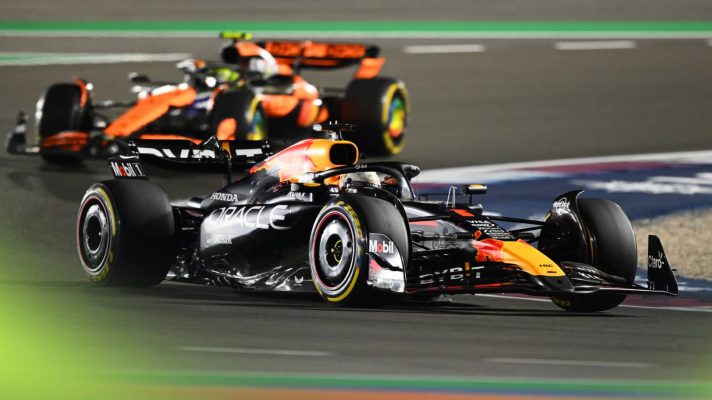 Max Verstappen exiting a corner in Qatar with Lando Norris in the background