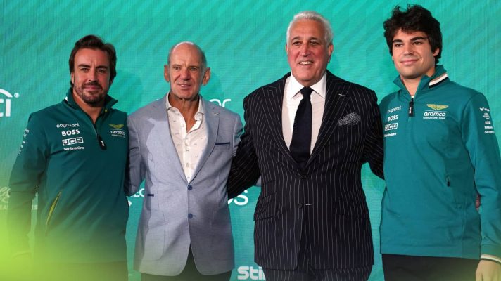 Fernando Alonso, Adrian Newey, Lawrence Stroll and Lance Stroll stand arm in arm