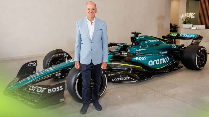Adrian Newey poses in front of an Aston Martin F1 car
