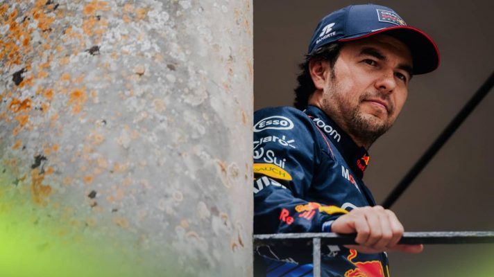 Sergio Perez rests his hand on the barrier at Goodwood with a pillar alongside him