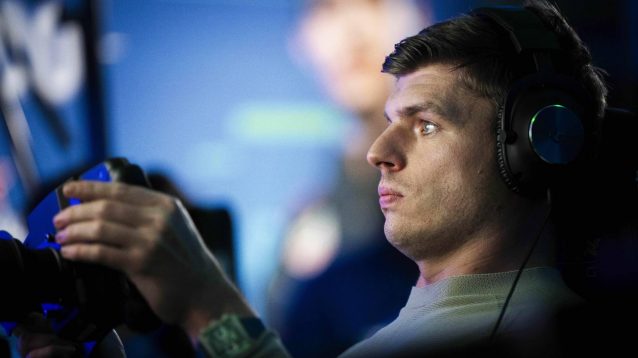 Max Verstappen behind a sim racing wheel.