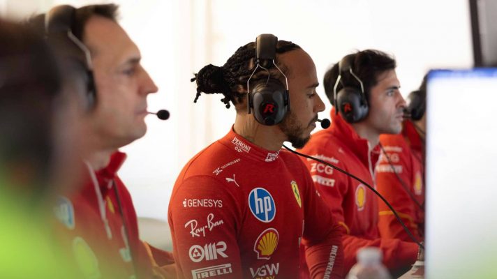 Lewis Hamilton wearing headphones in a Ferrari engineering meeting