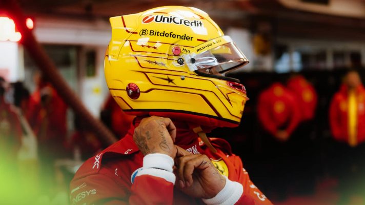 Lewis Hamilton fastening his new yellow helmet in the Ferrari garage at Fiorano