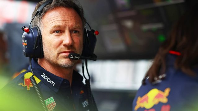 Christian Horner looks alarmed while sitting on the Red Bull pit wall