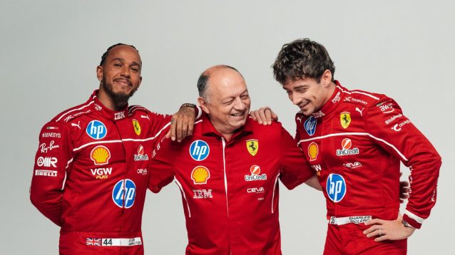 Lewis Hamilton looks on as Fred Vasseur and Charles Leclerc laugh together