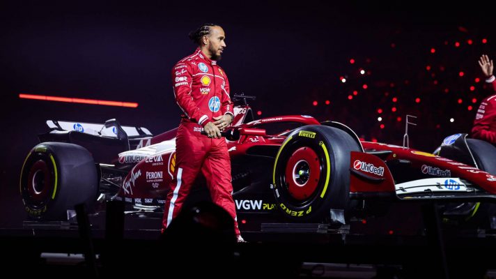 Lewis Hamilton stood with the Ferrari SF-25 at the London livery launch