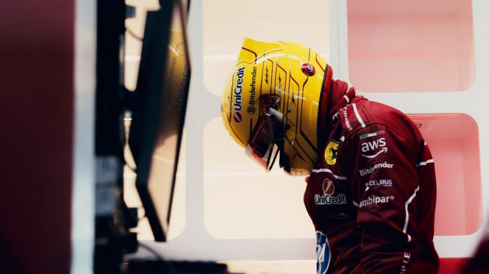 Lewis Hamilton lowers his head as he weighs himself during Ferrari's shakedown at Fiorano