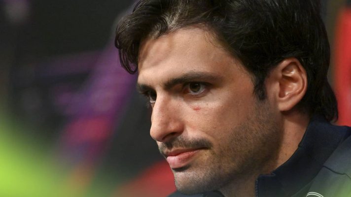 A close-up shot of Carlos Sainz in a press conference