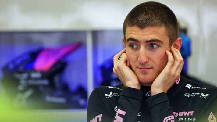 Jack Doohan holds his fingers in his ears in the Alpine garage
