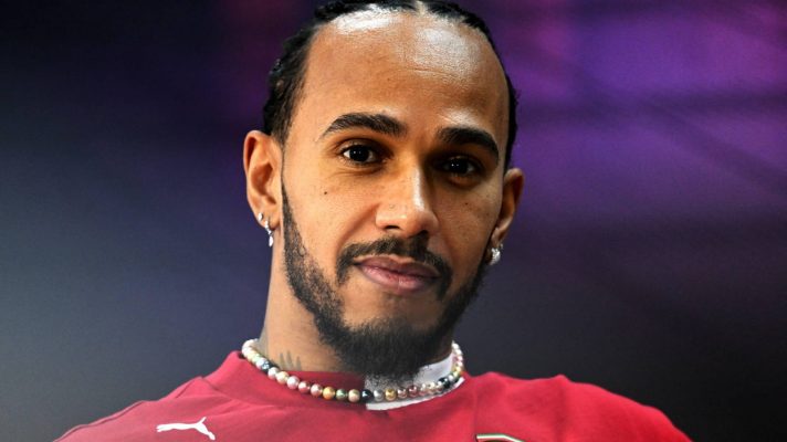 Ferrari driver Lewis Hamilton smiles and looks at the camera at 2025 Bahrain pre-season testing