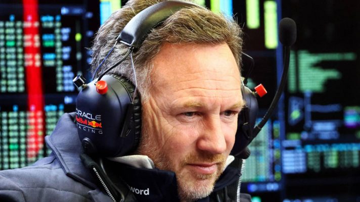 Red Bulll team principal Christian Horner surrounded by data screens in the garage at Bahrain F1 2025 testing