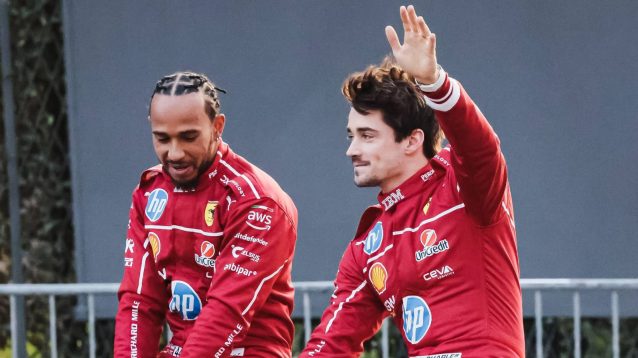 Charles Leclerc waves alongside Ferrari team-mate Lewis Hamilton at a Milan street event