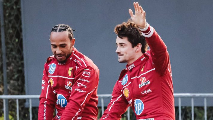 Charles Leclerc waves alongside Ferrari team-mate Lewis Hamilton at a Milan street event