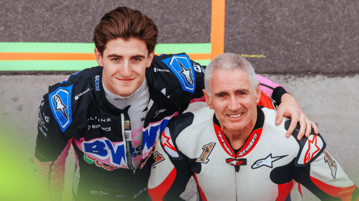 Jack Doohan and Mick Doohan pose together in the F1 pit lane