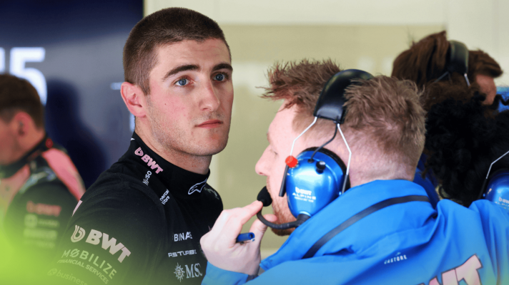 Jack Doohan looks on in the Alpine garage with an engineer in the foreground