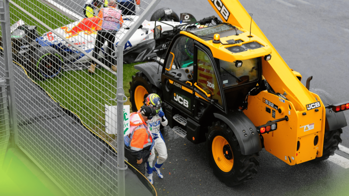 Isack Hadjar walks away from his stricken Racing Bulls car as a recovery vehicle arrives