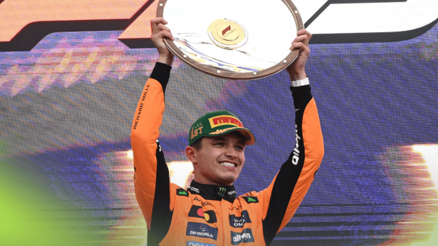 Lando Norris smiles as he lifts the winners' trophy on the Australian GP podium