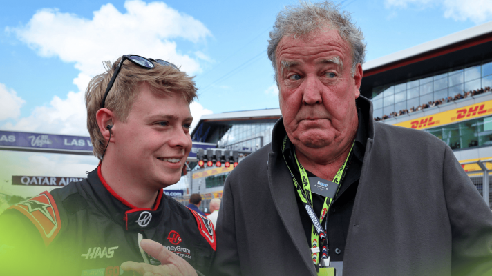 Jeremy Clarkson pulls a face as he stands next to a smiling Haas mechanic on the grid at Silverstone
