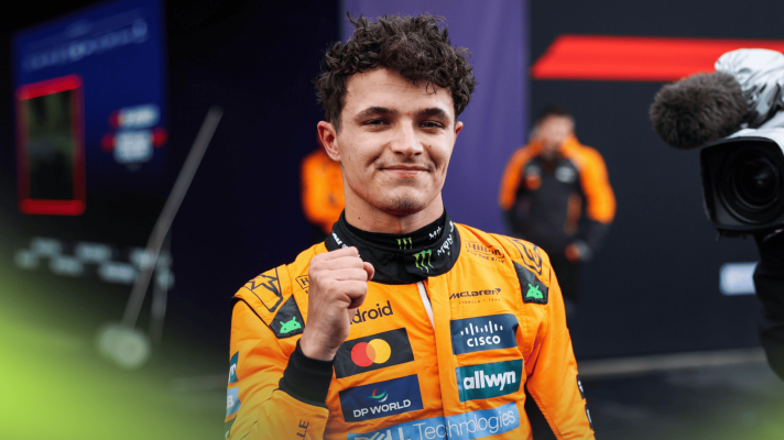 Lando Norris smiles as he holds up his fist after winning the Australian Grand Prix
