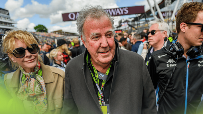 Jeremy Clarkson smiles as he walks on the packed grid at the 2024 British Grand Prix