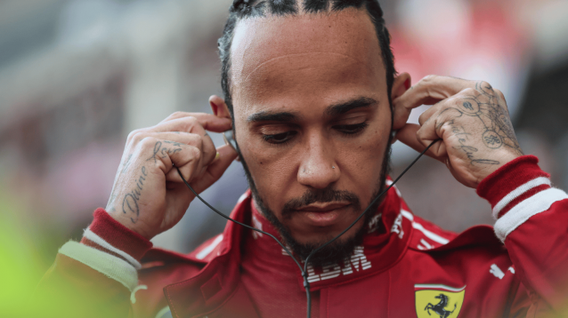 A close-up shot of Lewis Hamilton inserting his earplugs on the grid in China
