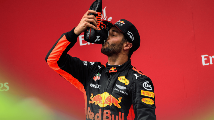 Daniel Ricciardo drinks out of his shoe in celebration on the podium