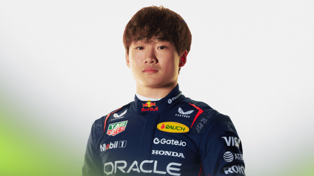 A studio shot of Yuki Tsunoda wearing Red Bull Racing overalls