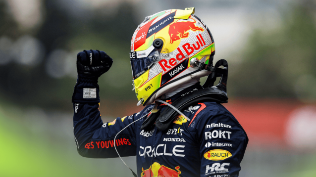 Sergio Perez punches the air with his helmet on after winning in Baku in 2023