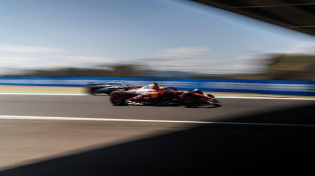 Blurred, Ferrari's Lewis Hamilton alongside Mercedes' George Russell, at the 2025 Japanese Grand Prix