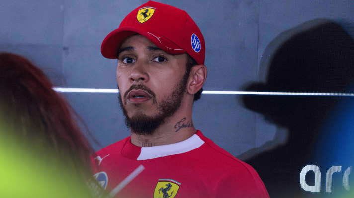 Lewis Hamilton looks distressed as he faces the media