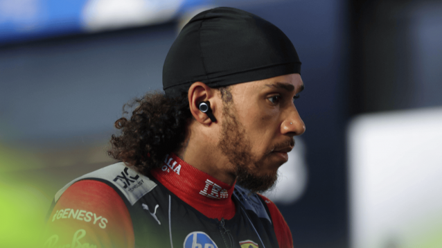 Lewis Hamilton looks stern as he makes his way through the pit lane ahead of the start in Saudi Arabia
