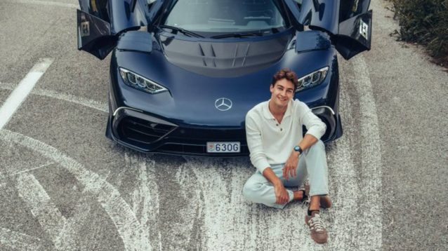 George Russell poses with his new Mercedes-AMG One.