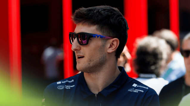 Jack Doohan wearing sunglasses as he makes his way through the paddock at Imola