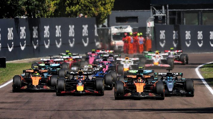 The field is spread out across the track as it races to Turn 1 shortly after the start of the Emilia Romagna Grand Prix.