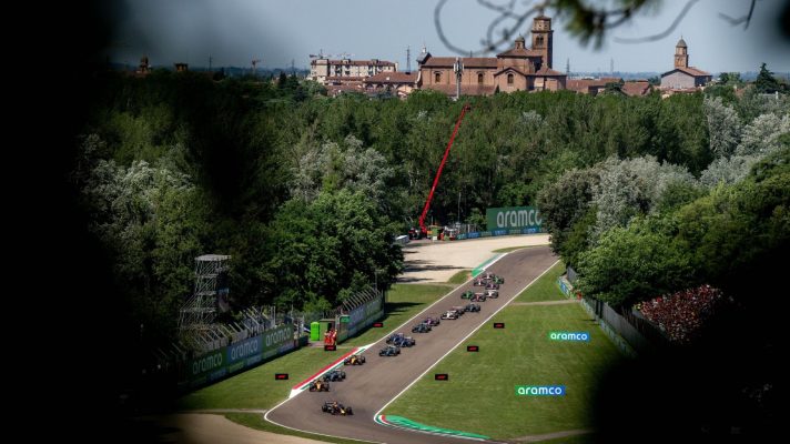 From the hill overlooking Tosa, in the distance, the F1 field races towards the Villeneuve chicane on the opening lap.