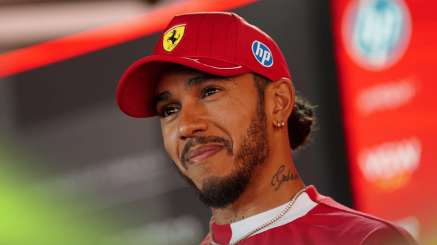 Lewis Hamilton smiles as he faces the media at Imola