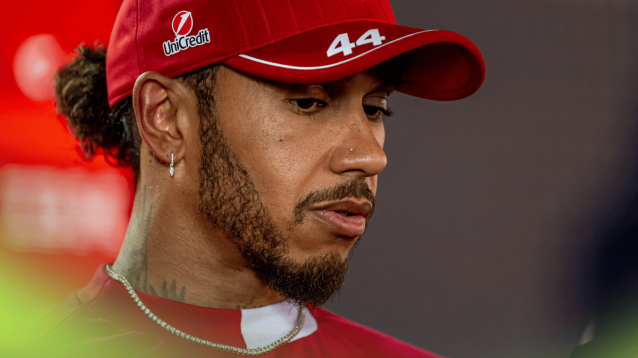 Lewis Hamilton looks down as he speaks to the media at Imola
