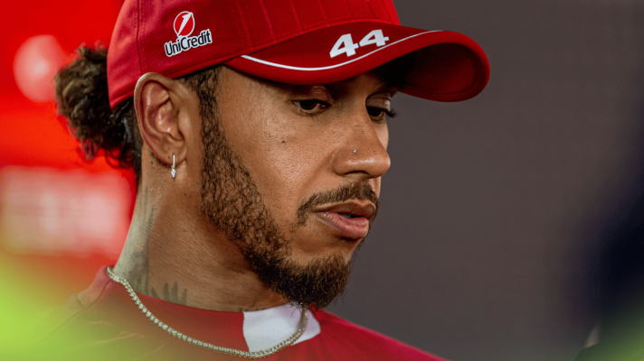 Lewis Hamilton looks down as he speaks to the media at Imola