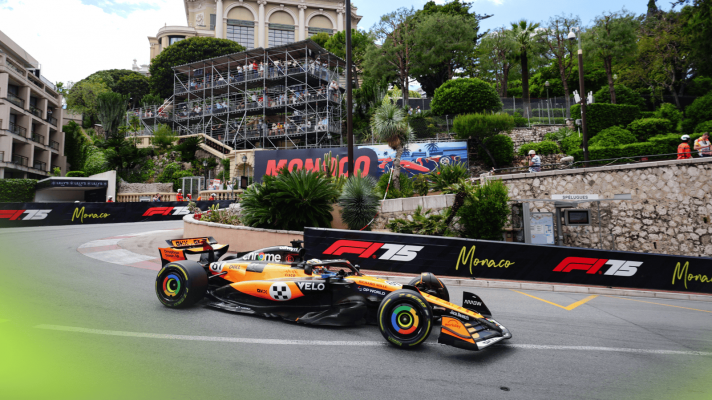 Oscar Piastri's McLaren on track in Monaco with the local scenery in the backdrop