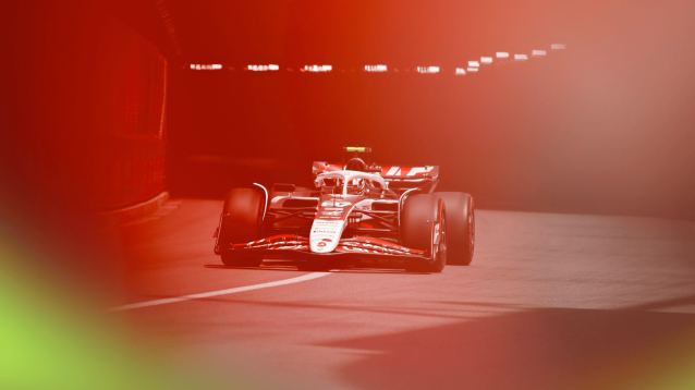 Oliver Bearman's Haas emerging from the Monaco tunnel with a red filter