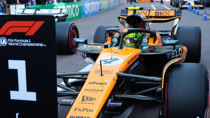 Lando Norris parks his McLaren in front of the no. 1 board in parc ferme after taking pole for the Monaco Grand Prix.