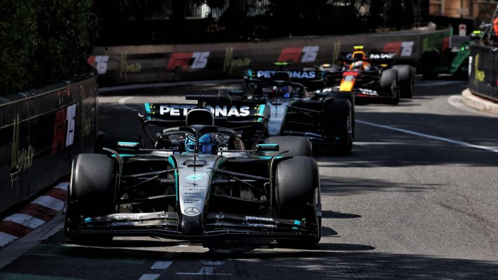 George Russell approaches the Fairmont Hairpin at the head of a train of cars during the Monaco Grand Prix.