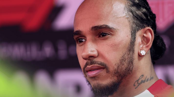 A close-up shot of Lewis Hamilton facing the media