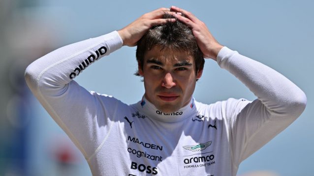 Lance Stroll with his hands on his head