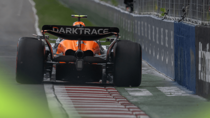A rear-facing shot of Lando Norris's McLaren exiting the final corner in Canada